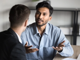 man talking with another man using hands