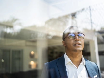 man looking out of window