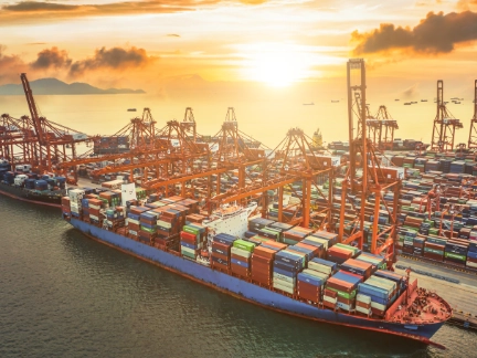 Aerial view of large ship in dock with containers