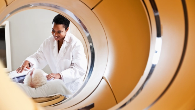 Medical scanning machine with patient and doctor in the back ground
