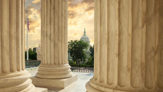 capitol building through columns of supreme court
