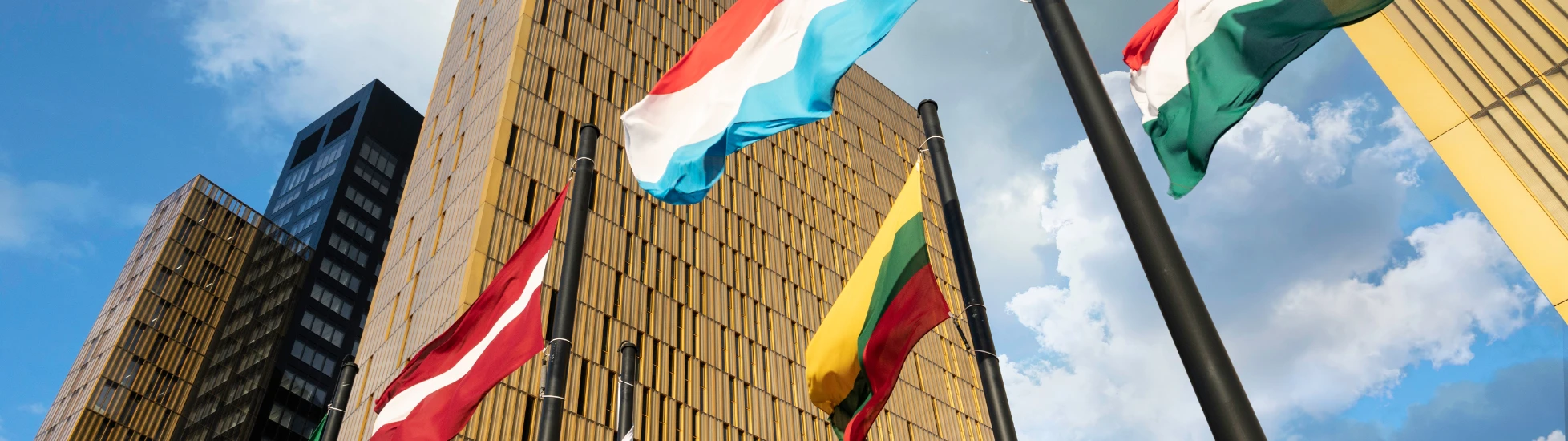 European Flags flapping in the wind, in front of European Union Court of Justice building in Luxembourg Ki