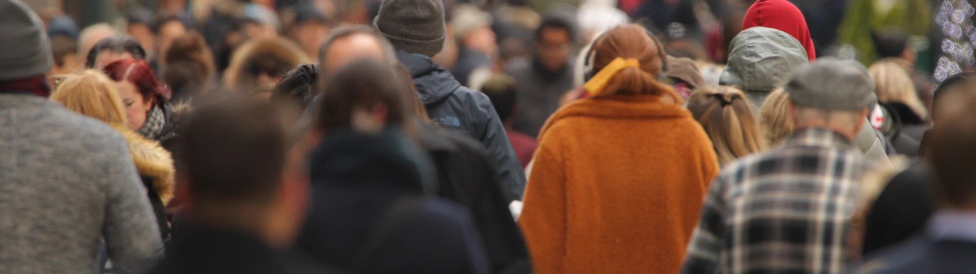 Crowd of people walking down a busy street