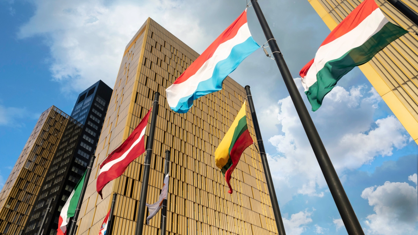 European Flags flapping in the wind, in front of European Union Court of Justice building in Luxembourg Ki