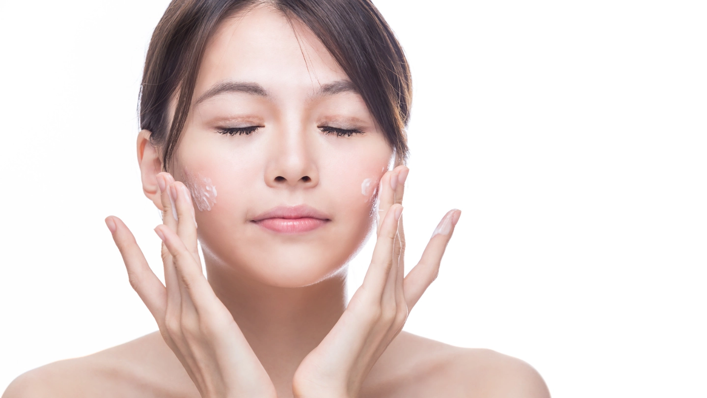 Asian lady L'oreal case study East Asian woman applying skincare to her face