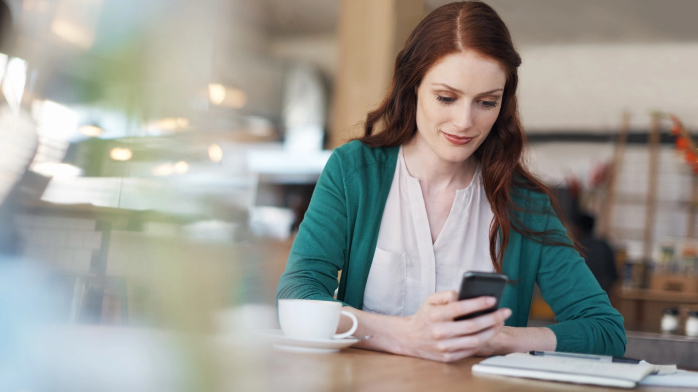 Woman looking at mobile phone image