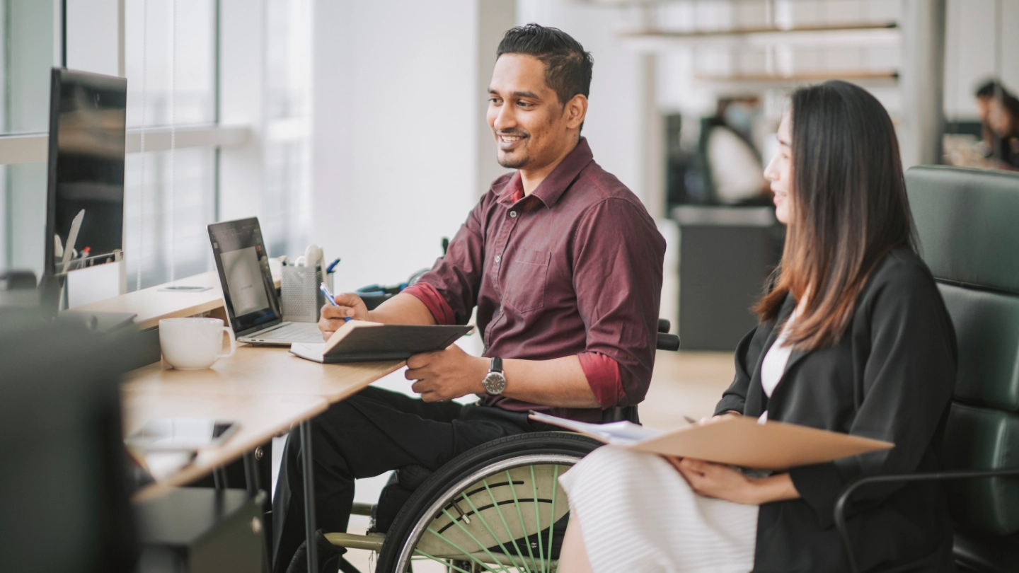 disabled man having a meeting with a woman colleague