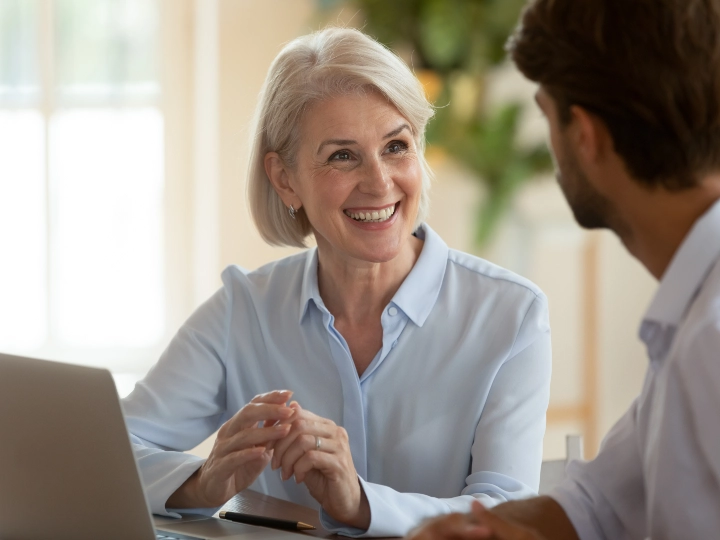 Middle aged woman talking to a male colleague